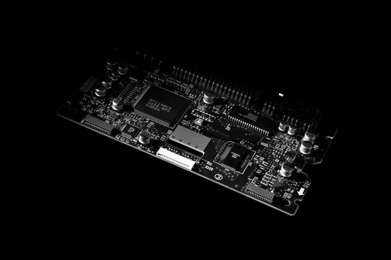 hero-img-02 Detailed black and white image of a computer circuit board, showcasing technology components.