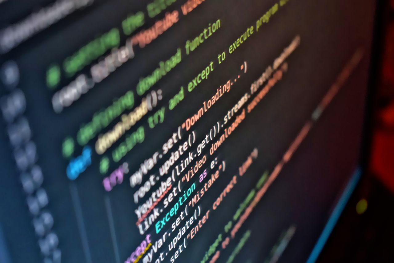 hero-img-01 Vivid close-up of code on a computer screen showcasing programming details.